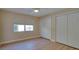 Simple bedroom with natural light, neutral walls, ceiling fan, and closet doors at 6528 Santiago Ct, Apollo Beach, FL 33572