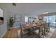 Open-concept dining area with large table and seating, opening onto a patio at 6528 Santiago Ct, Apollo Beach, FL 33572