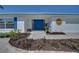 A charming home with a bright blue double-door entry, a white brick facade and neatly landscaped front yard at 6528 Santiago Ct, Apollo Beach, FL 33572