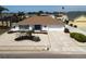 Charming single-story home boasts a well-maintained yard with decorative landscaping and a two-car garage at 6528 Santiago Ct, Apollo Beach, FL 33572
