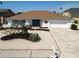 Charming single-story home boasts a well-maintained yard with decorative landscaping and a two-car garage at 6528 Santiago Ct, Apollo Beach, FL 33572
