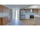 Modern kitchen features stainless steel appliances, wood cabinets, and hardwood floors at 6528 Santiago Ct, Apollo Beach, FL 33572