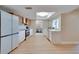Modern kitchen with white cabinetry, stainless steel appliances, and luxury vinyl plank flooring at 6528 Santiago Ct, Apollo Beach, FL 33572