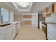 Bright, modern kitchen with stainless steel appliances, luxury vinyl plank flooring, and lots of natural light at 6528 Santiago Ct, Apollo Beach, FL 33572