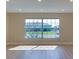 Well-lit room with recessed lighting, luxury vinyl plank flooring and large window overlooking front yard at 6528 Santiago Ct, Apollo Beach, FL 33572