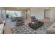 Bright living room featuring modern furniture, sleek decor, and sliding glass doors to a patio at 6528 Santiago Ct, Apollo Beach, FL 33572