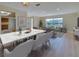 Open layout with luxury vinyl plank, dining area with marble table, and cozy living room at 6528 Santiago Ct, Apollo Beach, FL 33572