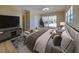 Spacious main bedroom featuring light wood floors and sliding glass doors to the backyard at 6528 Santiago Ct, Apollo Beach, FL 33572