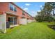 Backyard with grass lawn and white fences, showing the property's serene view of the water and greenery at 6831 Dartmouth Hill St, Riverview, FL 33578