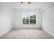Bright bedroom with new flooring and a large window overlooking the pond and backyard at 6831 Dartmouth Hill St, Riverview, FL 33578