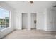 Light-filled bedroom showcasing wood floors, window view, and double closets at 6831 Dartmouth Hill St, Riverview, FL 33578