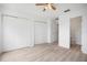 Bright bedroom boasts wood floors, ceiling fan, and closet space at 6831 Dartmouth Hill St, Riverview, FL 33578