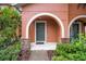 Charming covered front entrance with brick columns, welcome mat and green door with the house number above at 6831 Dartmouth Hill St, Riverview, FL 33578