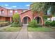 Charming townhome with lovely landscaping, sidewalk and covered entrances with beautiful arches and green doors at 6831 Dartmouth Hill St, Riverview, FL 33578