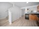 Bright kitchen with wood cabinets, modern appliances, staircase and luxury vinyl plank flooring at 6831 Dartmouth Hill St, Riverview, FL 33578