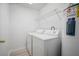 Convenient laundry room with washer, dryer, shelf and water heater at 6831 Dartmouth Hill St, Riverview, FL 33578