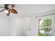 Bright living room with a modern ceiling fan, neutral paint, and large window at 6831 Dartmouth Hill St, Riverview, FL 33578