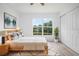 Tranquil main bedroom with new flooring and a large window overlooking the pond and backyard at 6831 Dartmouth Hill St, Riverview, FL 33578