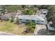 Aerial view of home with a well-manicured lawn and fenced yard with a shed at 736 85Th N Ave, St Petersburg, FL 33702