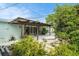 Outdoor patio area surrounded by lush landscaping and a small decorative water feature at 736 85Th N Ave, St Petersburg, FL 33702