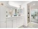 Well-lit bathroom featuring a double vanity, ample storage, and a separate shower, offering comfort and convenience at 736 85Th N Ave, St Petersburg, FL 33702