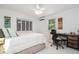 Comfortable bedroom with neutral tones, tile flooring, featuring a ceiling fan, natural light, and closet at 736 85Th N Ave, St Petersburg, FL 33702