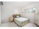 Bright bedroom with a comfortable bed, neutral decor, and tile flooring for a clean and modern look at 736 85Th N Ave, St Petersburg, FL 33702