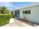 Front entrance featuring fresh paint, decorative rock, and manicured hedges at 736 85Th N Ave, St Petersburg, FL 33702