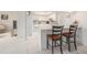 Modern, updated kitchen with an eat-in bar and white cabinetry at 736 85Th N Ave, St Petersburg, FL 33702