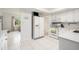 Well-lit kitchen featuring white appliances and ample space at 736 85Th N Ave, St Petersburg, FL 33702