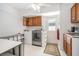 Functional laundry room with washer, dryer, and storage cabinets at 736 85Th N Ave, St Petersburg, FL 33702