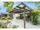 Outdoor patio with dining, lounge furniture, decorative lighting, and lush tropical landscaping at 736 85Th N Ave, St Petersburg, FL 33702
