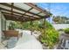 Covered patio surrounded by lush landscaping creating a serene outdoor living space at 736 85Th N Ave, St Petersburg, FL 33702