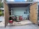 Open shed with equipment and tools in a gravel lot, providing a space for storage and projects at 736 85Th N Ave, St Petersburg, FL 33702