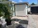 View of a storage shed with white siding and a gravel base at 736 85Th N Ave, St Petersburg, FL 33702