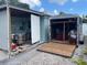 Storage shed with double doors and a trailer on the gravel area of the property at 736 85Th N Ave, St Petersburg, FL 33702