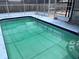 Home's screened-in pool with water and steps at 7421 Moravian Dr, Port Richey, FL 34668