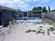 Enclosed pool and screen with sand and minimal grass in backyard at 7421 Moravian Dr, Port Richey, FL 34668