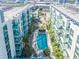 Aerial view of the condominium complex featuring a large pool, courtyard, and surrounding palm trees at 912 Channelside Dr # 2710, Tampa, FL 33602