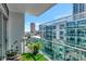Condo balcony showcasing sleek glass railing, city views, and a cozy seating area at 912 Channelside Dr # 2710, Tampa, FL 33602