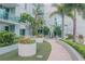 Lush courtyard featuring tropical plants, decorative planters, and a tranquil water feature at 912 Channelside Dr # 2710, Tampa, FL 33602