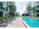 Inviting pool area with lounge chairs, tropical landscaping, and well-maintained walkways at 912 Channelside Dr # 2710, Tampa, FL 33602
