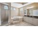 Bright bathroom featuring a glass shower, garden tub, arched windows, and double vanity at 9127 Irondale Ln, Hudson, FL 34667