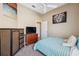Well-lit bedroom featuring a blue plaid bedspread, closet, and artistic wall decor at 9127 Irondale Ln, Hudson, FL 34667