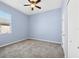 Simple carpeted bedroom with a window and a ceiling fan at 9127 Irondale Ln, Hudson, FL 34667