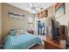Bright bedroom featuring a closet, blue bedding, carpeted floor and a ceiling fan at 9127 Irondale Ln, Hudson, FL 34667