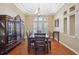 Formal dining area with a large wood table and chairs, tray ceiling, and elegant decor at 9127 Irondale Ln, Hudson, FL 34667