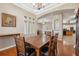 Elegant dining room with hardwood floors, chandelier, columns and view to the living room at 9127 Irondale Ln, Hudson, FL 34667