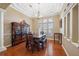 Elegant dining room with hardwood floors, tray ceilings, and classic furniture at 9127 Irondale Ln, Hudson, FL 34667