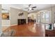 Spacious living room with hardwood floors, a fireplace, and views into the adjacent dining area at 9127 Irondale Ln, Hudson, FL 34667